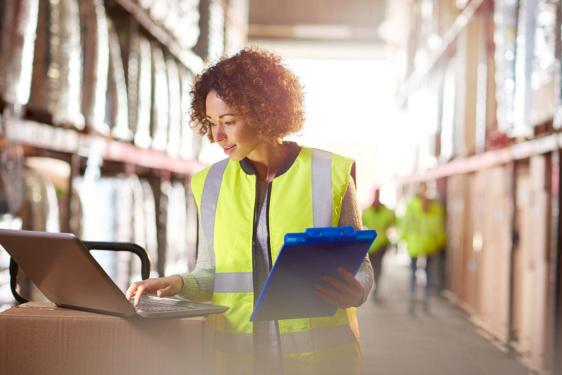 Woman in vest with clipboard