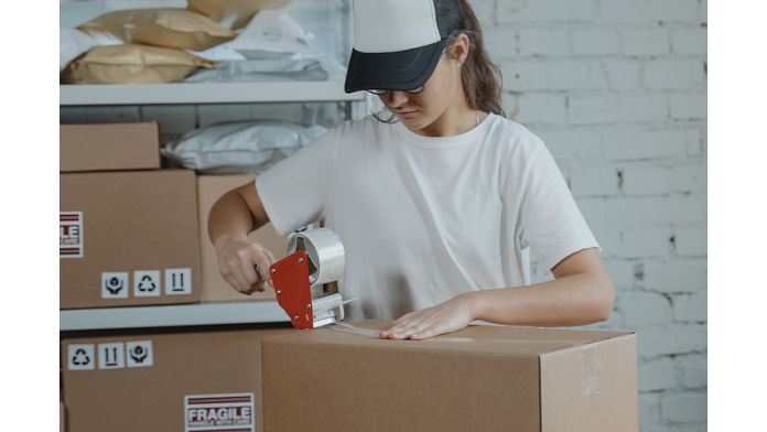 Person taping boxes