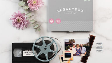 Overhead view of a LegacyBox with flowers, video tapes, pictures, and barcodes