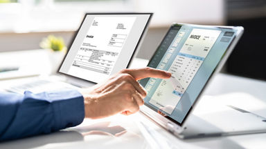 Someone's hand using a touchscreen laptop.