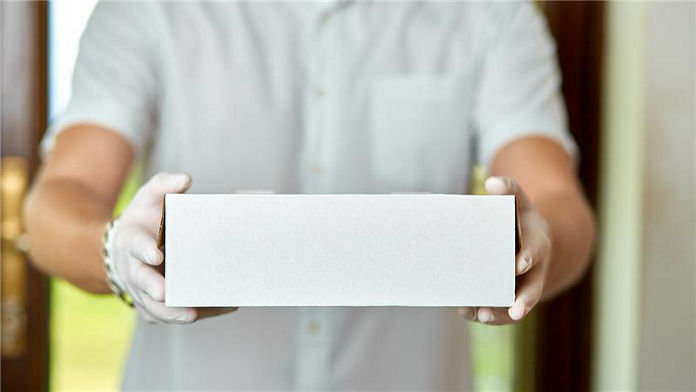 white glove holding a box