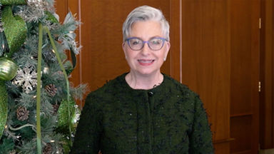 UPS employee next to Christmas tree