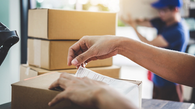 Person putting a label on a package