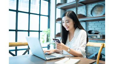 Technology, Online shopping, Digital banking, home lifestyle concept, a beautiful Smiling Asian woman with a laptop computer and credit card at home for business payment, career, e-commerce trading 