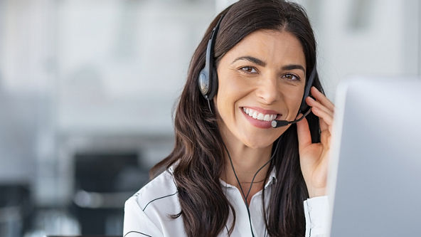 Female wearing a headset and holding the side