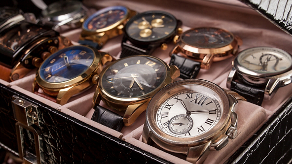 Luxury watches displayed in black leather box 