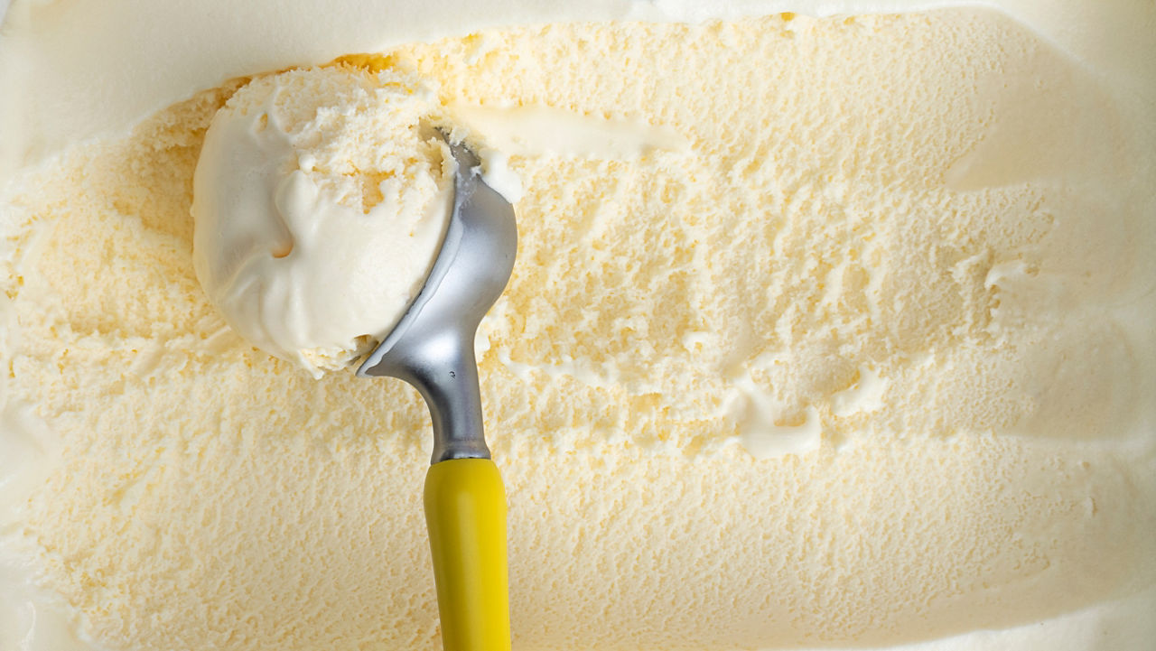 Close up Vanilla ice cream scooped out from container with a spoon, Food concept.; Shutterstock ID 1808391766; purchase_order: na; job: ; client: ; other: 