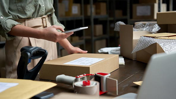 Female taking a photo with her phone of a package