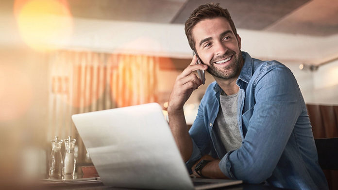 male on phone and laptop