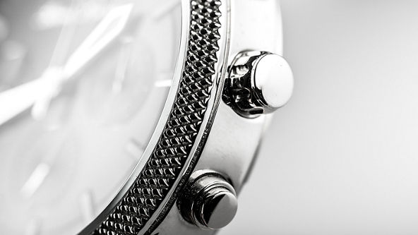 Close up of the dials on a silver watch 
