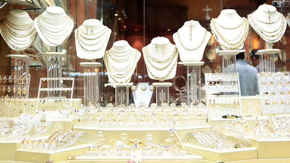 Jewelry store display window full of gold jewelry 