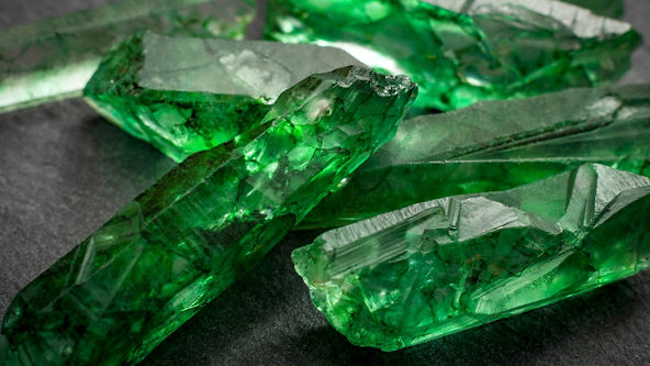 Close up of rough cut green gemstones 