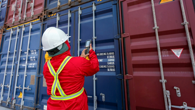 Person scanning an ocean freight container